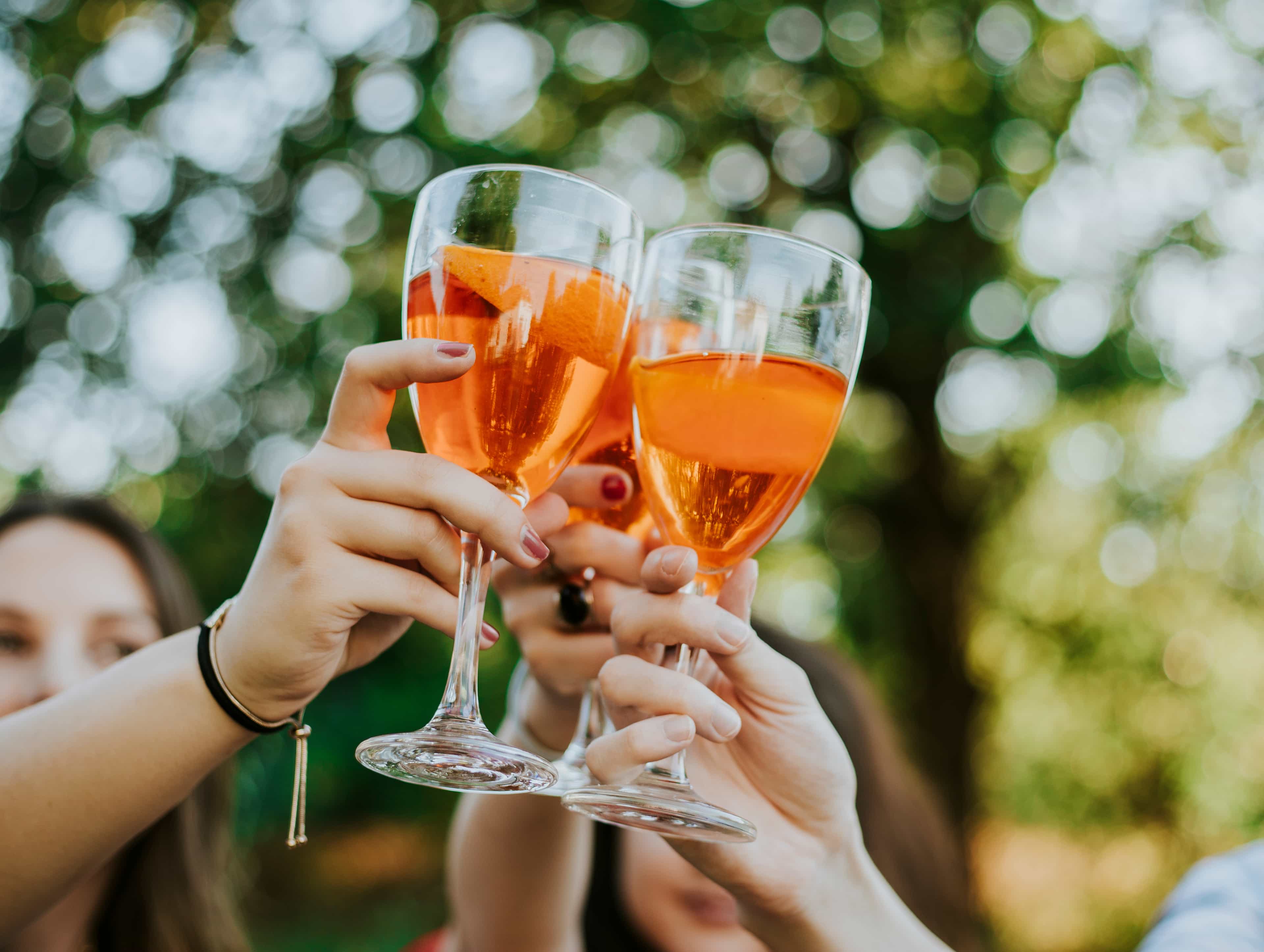 A group cheers outdoors with fresh made cocktails