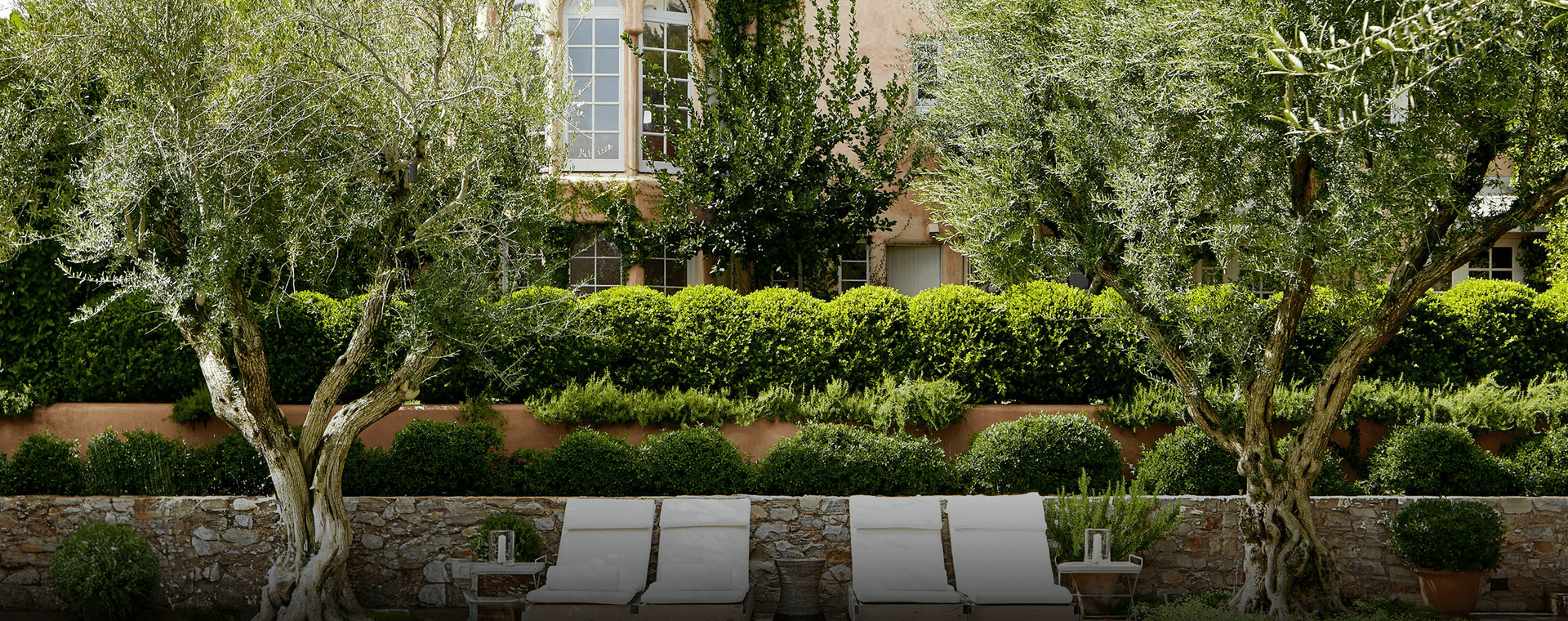 A luxury home with a stylish mediterranean estate landscape.